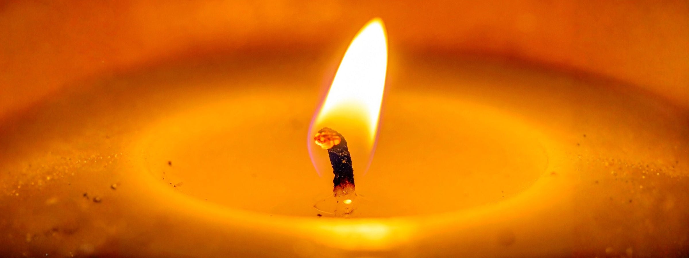 a close up of a burning candle wick