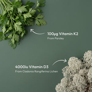 HOVER - A dark green background with fresh parsley in the top-left corner and pale sea-lily lichen in the bottom-right corner, with white text reading '100Ωg Vitamin K2 From Parsley' and '4000iu Vitamin D3 From Cladonia Rangiferina Lichen' with arrows pointing to the ingredients.