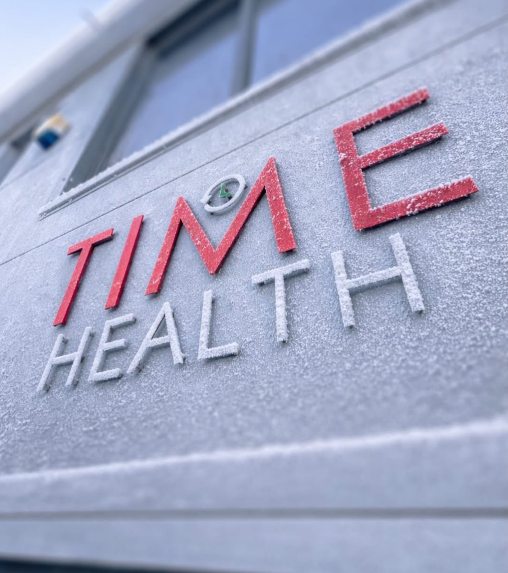 Time health logo on the front of our building covered in frost, wintery.