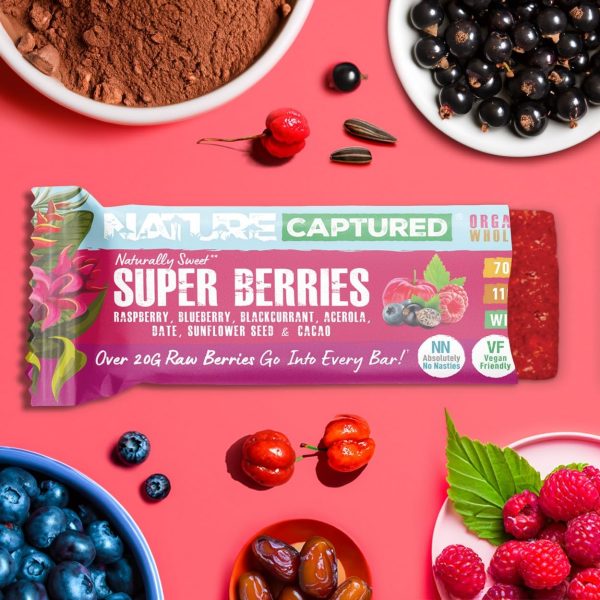 Pink background with nature captured organic berry bar surrounded by dates, acerola cherry for vitamin c, blackcurrants, raspberries, sunflower seeds and blueberries
